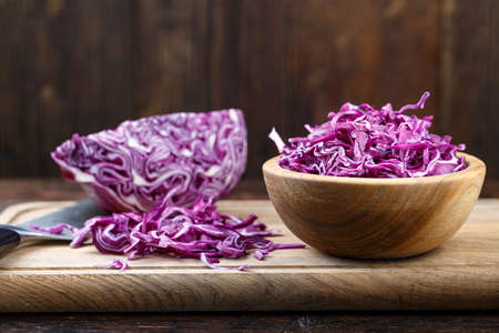 chopped purple cabbage in a plate on a cutting board. space for text