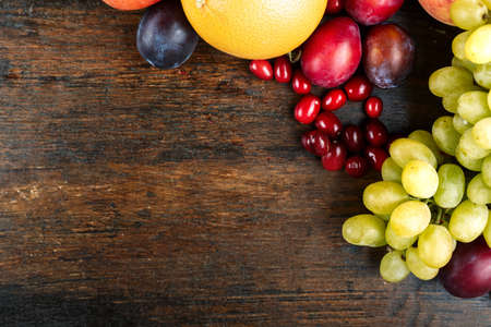 Set ripe fruit on a brown wooden background. space for textの写真素材