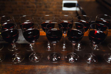 Glasses with red wine are lined up on the bar. welcome drinkの写真素材