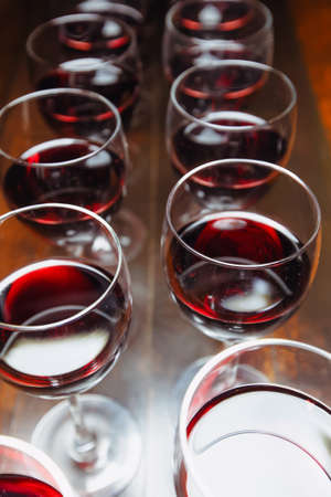 Glasses with red wine are lined up on the bar. welcome drinkの写真素材