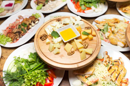 cheese platter appetizer. different festive dishes on the table in the restaurantの写真素材