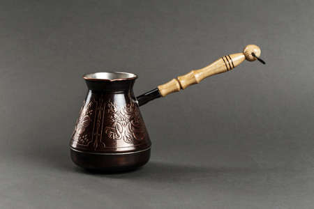 copper coffee pot on a black background. space for textの写真素材