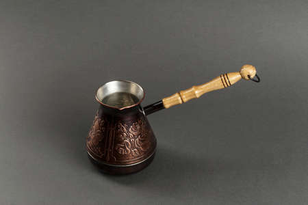 copper coffee pot on a black background. space for textの写真素材