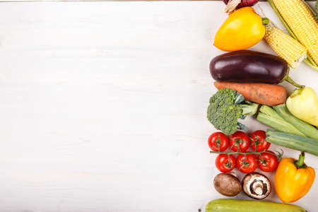 spring vegetables background. place for text on the side. on white wooden backgroundの写真素材