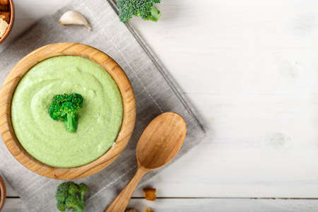 broccoli cream soup on a white table. nearby are spices. space for textの写真素材
