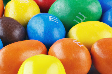 Kiev, Ukraine - December 21, 2018: M&M's candies. M&M's produced by Mars, Incorporated. Close up of a pile of colorful chocolate coated candy, chocolate pattern, candies background, top view.のeditorial素材