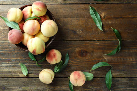 ripe ruddy organic peaches. harvest on a brown wooden table. space for textの写真素材