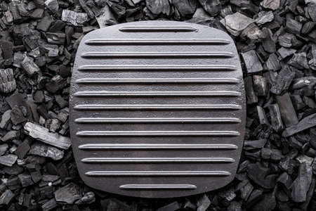 net grill pan stands on the coals. space for textの写真素材