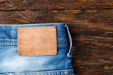 leather label without inscriptions on blue jeans close-up. clearly visible texture of the fabric. space for textの写真素材