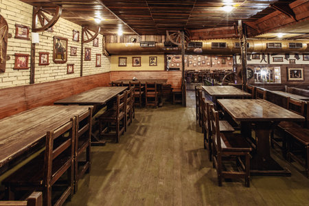 Kiev, Ukraine- march 19, 2018. Traditional Irish beer pub with a wooden interior. many empty tables and chairs.のeditorial素材