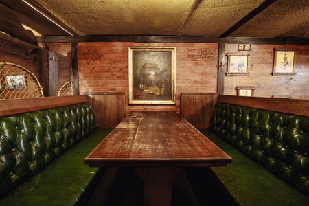 Kiev, Ukraine- March 19, 2018. a large table and sofas with leather green upholstery in a beer pub.のeditorial素材