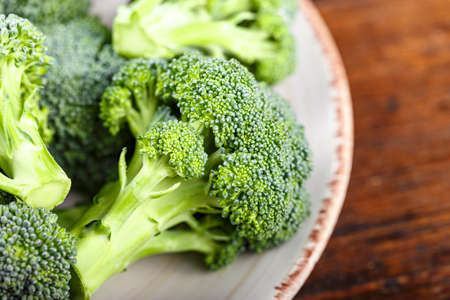 inflorescences of fresh raw broccoli cabbage on wooden background. space for textの写真素材
