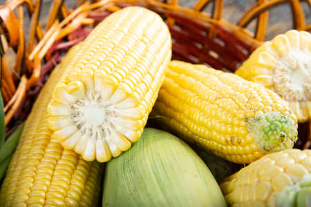 corn heads in the basket on the table. clearly visible texture of corn