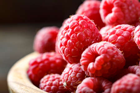 Fresh raspberry in a wooden plateの写真素材