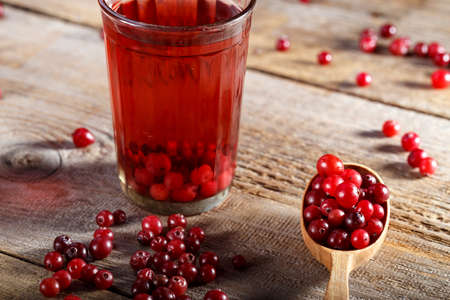 cranberry berry and cranberry drink on a brown wooden table. vitamin drinkの写真素材