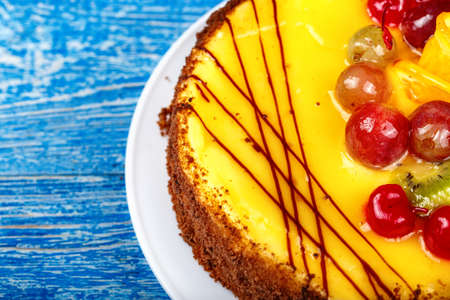 Delicious fruit cake on a blue background. Birthday fun holidayの写真素材