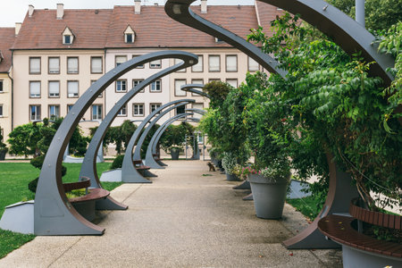 Colmar, France - July 26, 2017. Public park in front of the Building of the Edmond Gerrer municipal library, with modern urban arches. Sguare de la Montagne Verte, Town of Colmar, Alsaceのeditorial素材