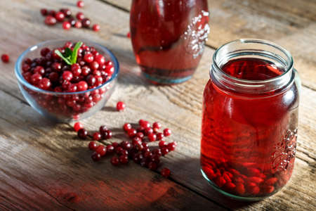 homemade vitamin drink. cranberry juice and fresh cranberries on the tableの写真素材