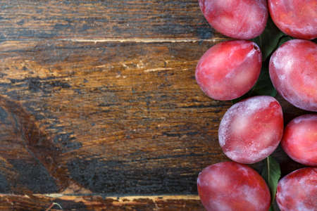 Ripe plums on a wooden background. Fresh fruitsの写真素材