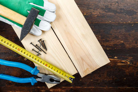 Various tools for work at home and for repair on a wooden background. Place for textの写真素材