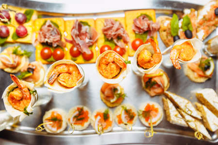 Various snacks from meat and seafood on the buffet table. birthday celebration in a restaurant. cateringの写真素材