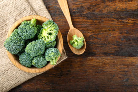Fresh broccoli cabbage on a brown wooden table in a plate. space for textの写真素材