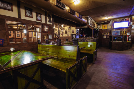 Kiev, Ukraine- March 19, 2018. empty wooden seating and tables in a beer pub. traditional beer pub with wooden interiorのeditorial素材