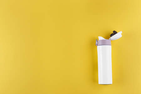 white bottle for travel, on a yellow background. place for textの写真素材