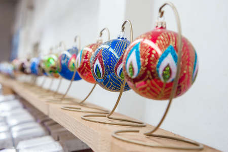 many new year's toys stand in a row on a shelf in a store. traditional christmas tree decorationの写真素材