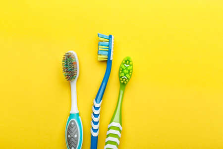 different toothbrushes lie in a row on a bright background. oral care. place for textの写真素材