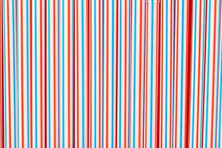 many plastic drinking straws laid out as a background. place for textの写真素材