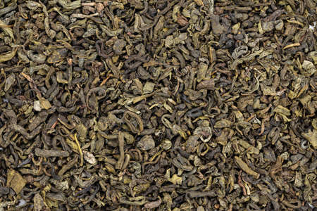 green tea is scattered as a background. natural antioxidant. traditional chinese drinkの写真素材
