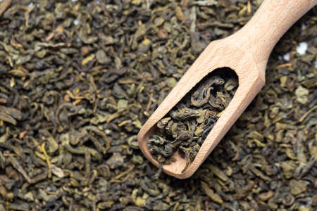 green tea is scattered as a background. natural antioxidant. traditional chinese drink