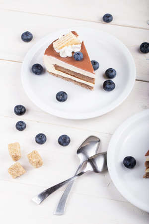 slice of chocolate or coffee cake in a plate on the table. tasty treat for the holidayの写真素材
