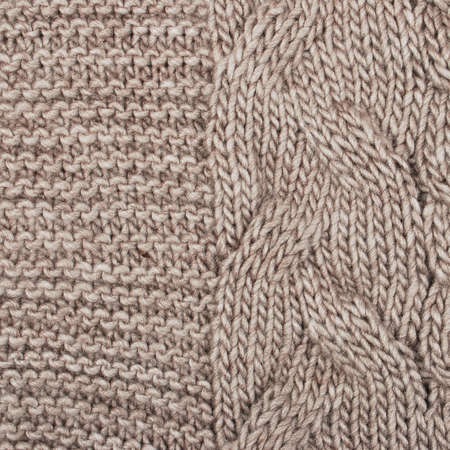 knitted warm background, element of a sweater or scarf. the texture of knitting and yarn is clearly...