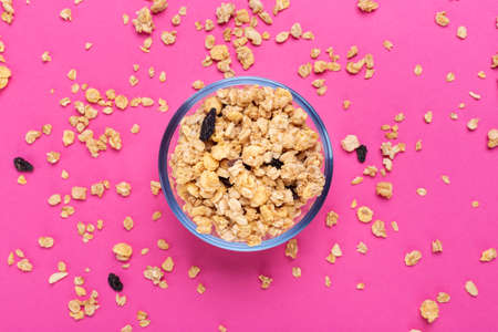 dry granola with nuts and dried fruits in a plate on the table. place for text