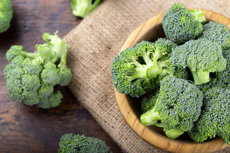 Fresh raw broccoli in a wooden bowl. Vegetarian food.の写真素材