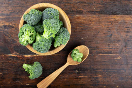 Fresh raw broccoli in a wooden bowl. Vegetarian food.の写真素材