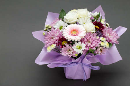 Fresh, lush bouquet of colorful flowers, on gray background. Top view.の写真素材