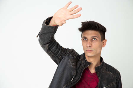 Expressive man in leather jacket on white background
