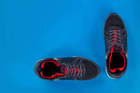 Insulated sneakers on a blue background. Warm shoes concept. Space for text.の写真素材