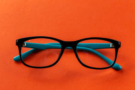 Glasses for sight on an orange background. Fashion accessories.の写真素材