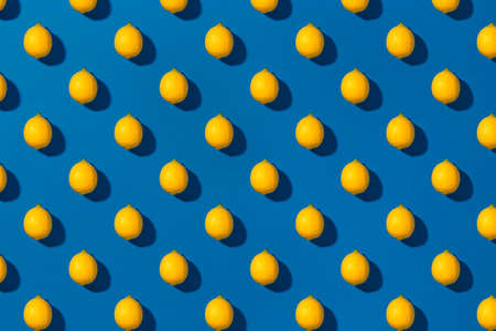 Patterns with fresh lemon on a blue background. Top viewの写真素材