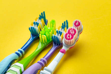 Toothbrushes on yellow background. Hygiene of the oral cavity. Top view.の写真素材
