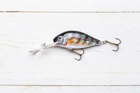 Wobbler perch or pike bait. Fishing bait tackle and baubles for fishing on a wood background.