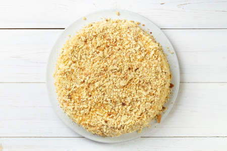 Homemade honey cake with sour cream on a white wooden table. Space for text. Top view.の写真素材