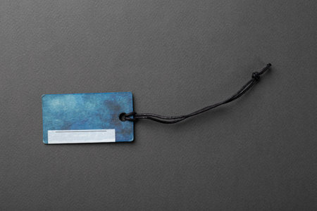Blank tag tied with string. Price tag, gift tag, sale tag, address label isolated on gray...