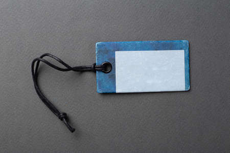 Clothing tag, label blank mockup template on a paper background. Price tag, gift tag, sale tag.の写真素材