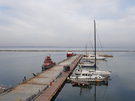 ODESSA, UKRAINE - October 24, 2020: Sea port. Expensive yachts and fire boats are moored at the pier. Marine transport concept.のeditorial素材
