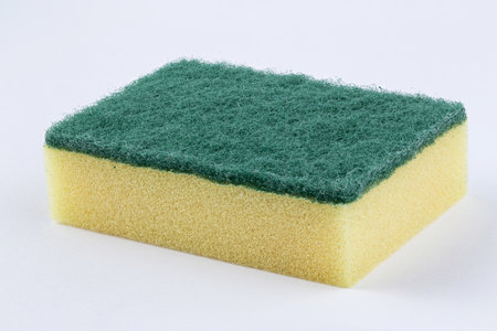 Yellow kitchen sponge against on white background. Scrub yellow sponge design, close up Cleaning sponge.の写真素材